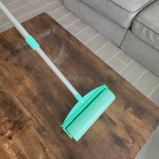 A roller cleaning a wooden table